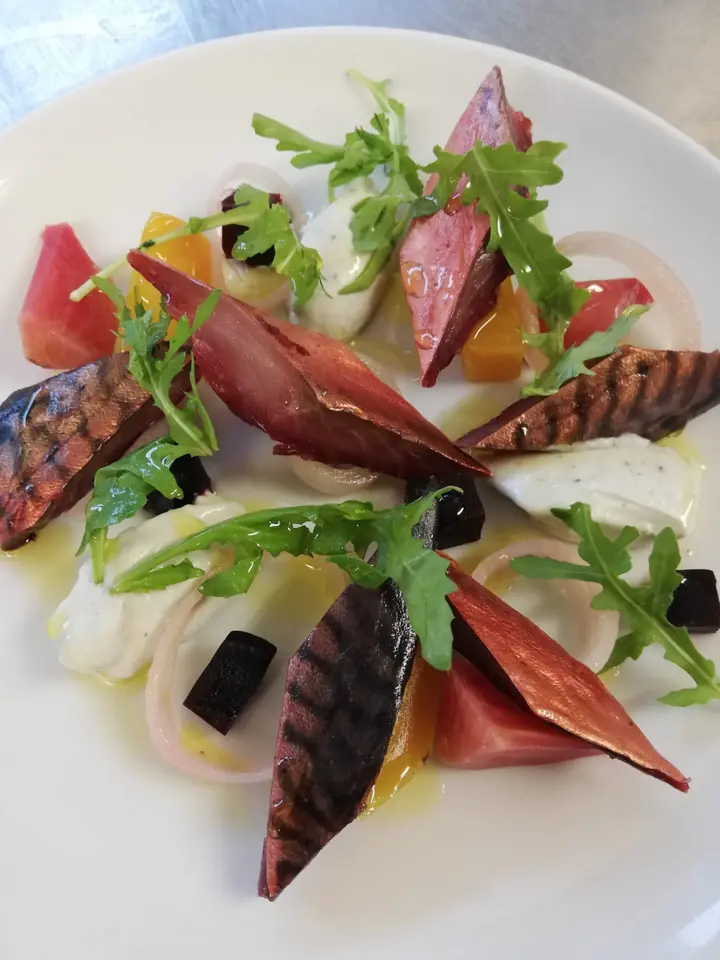Charred and golden beetroot with soft white cheese, pickled shallot and rocket